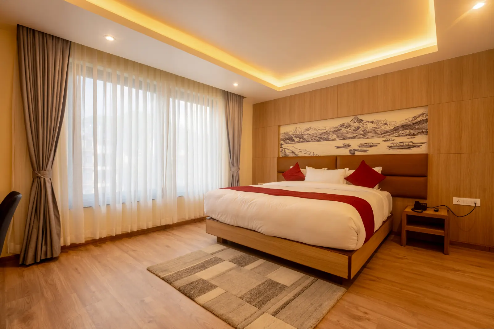 Spacious Hotel Lumen king room with warm timber walls and a wide window