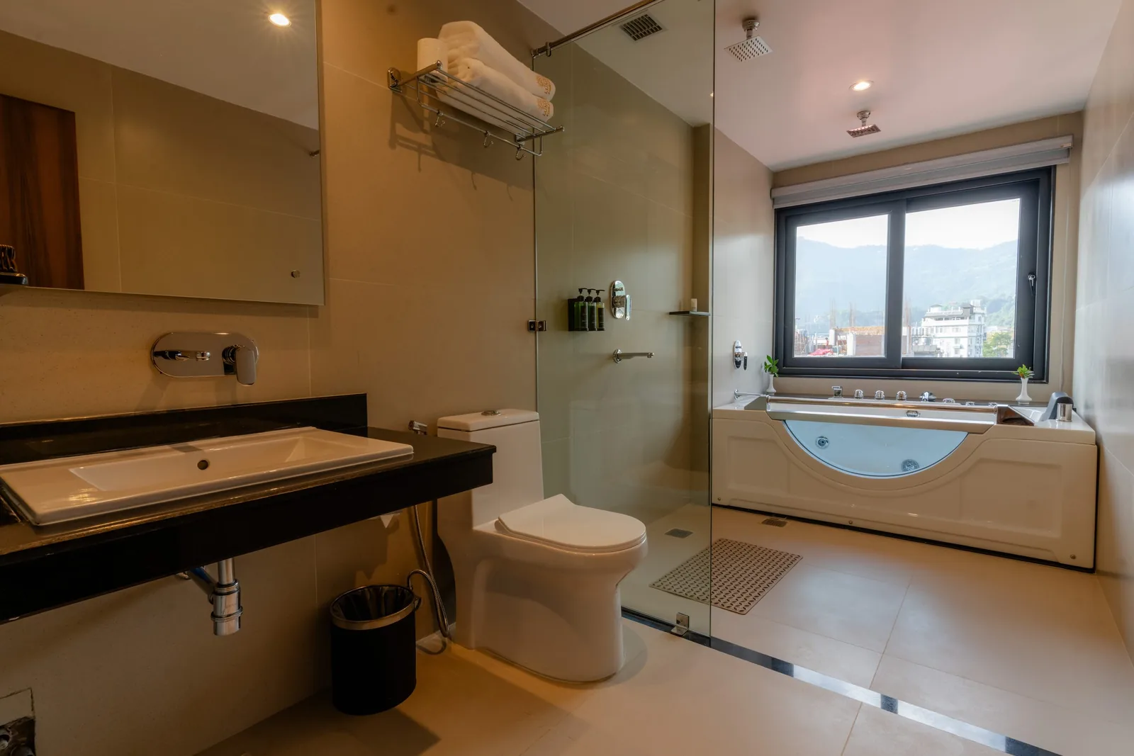 Hotel Lumen suite bathroom with private Jacuzzi and green-hill outlook