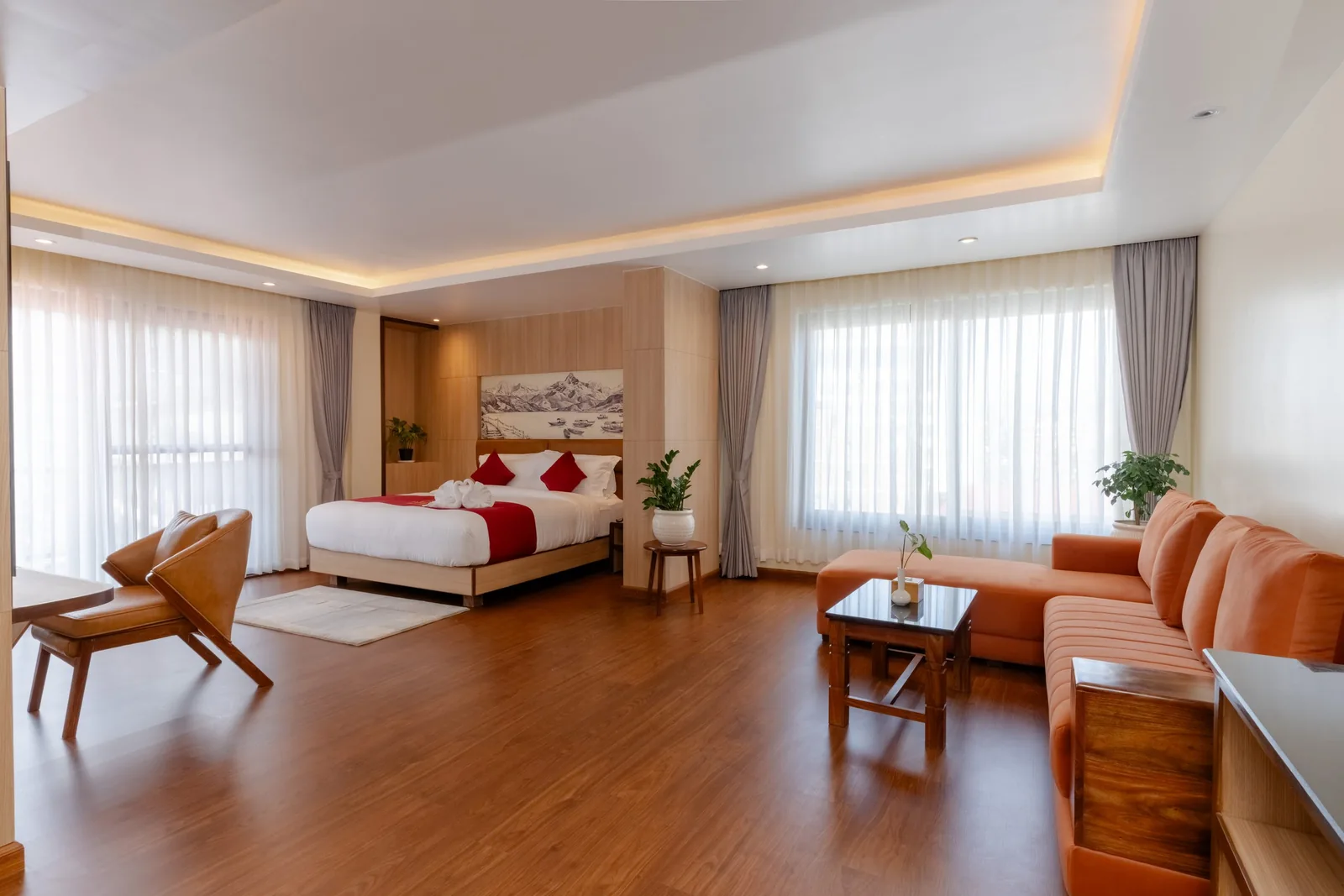 Sleeping and sitting areas with an orange sofa at Hotel Lumen