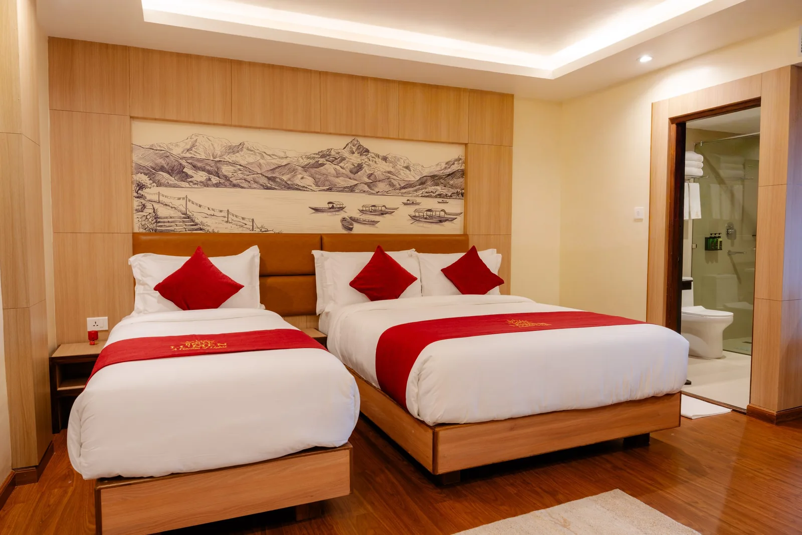 Two beds beside an open private bathroom at Hotel Lumen