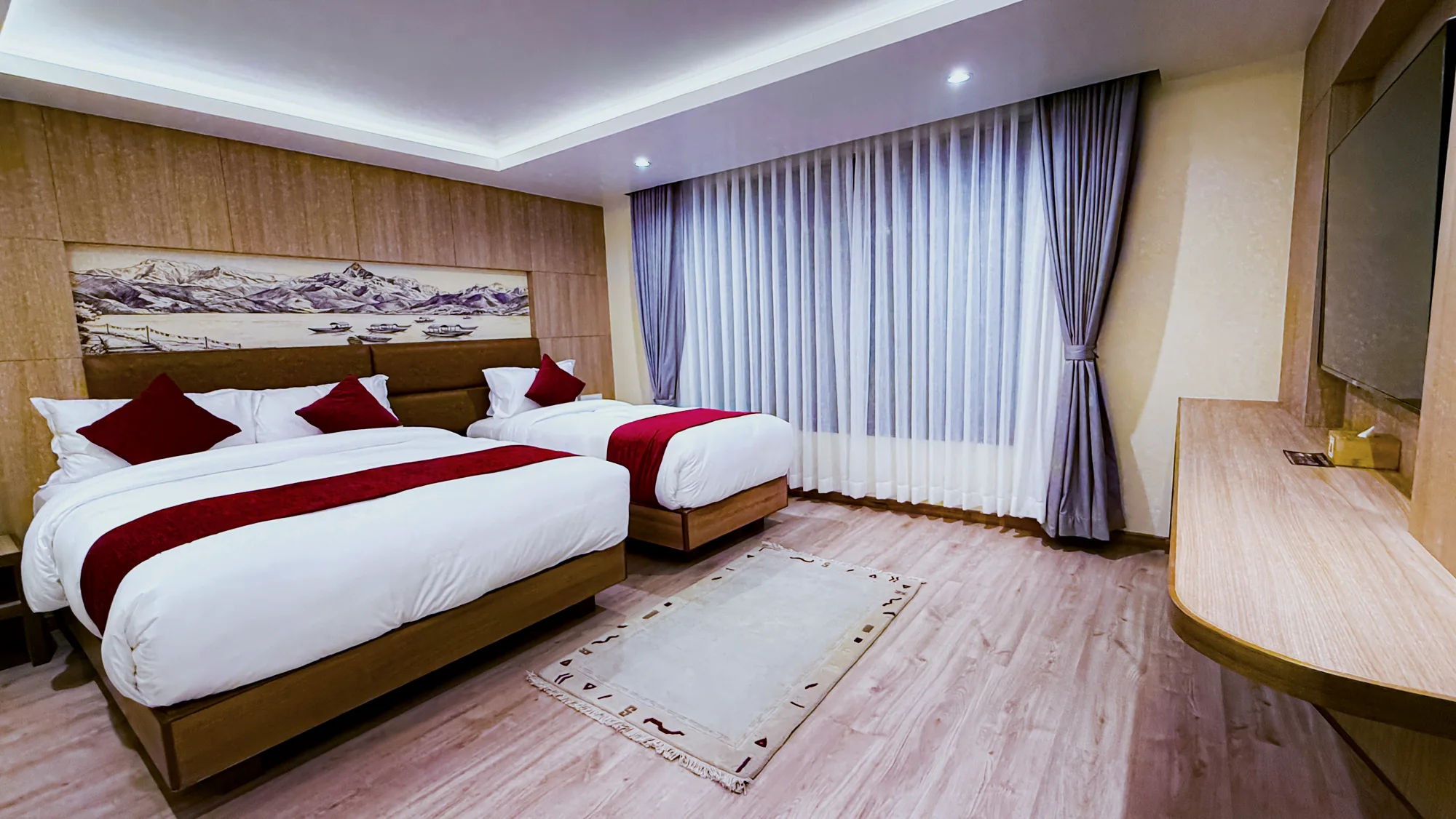 Spacious Hotel Lumen room with a large bed and single bed